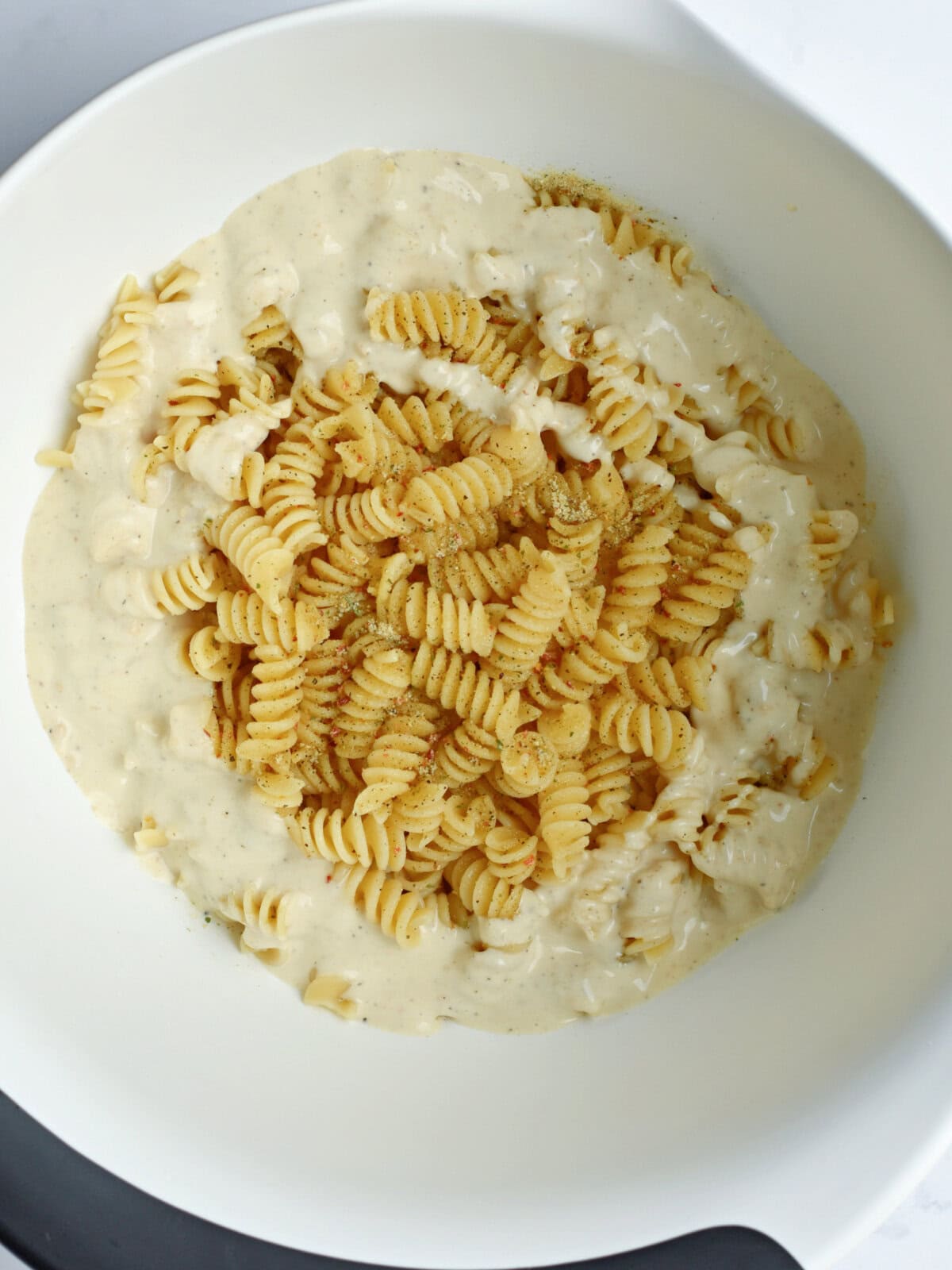 pasta-dressing-bowl A mixing bowl with pasta and salad dressing.