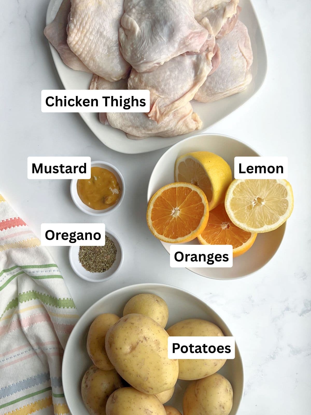 chicken-thighs-potatoes-ingredients Chicken thighs and potatoes dinner made with oranges, lemon, oregano.