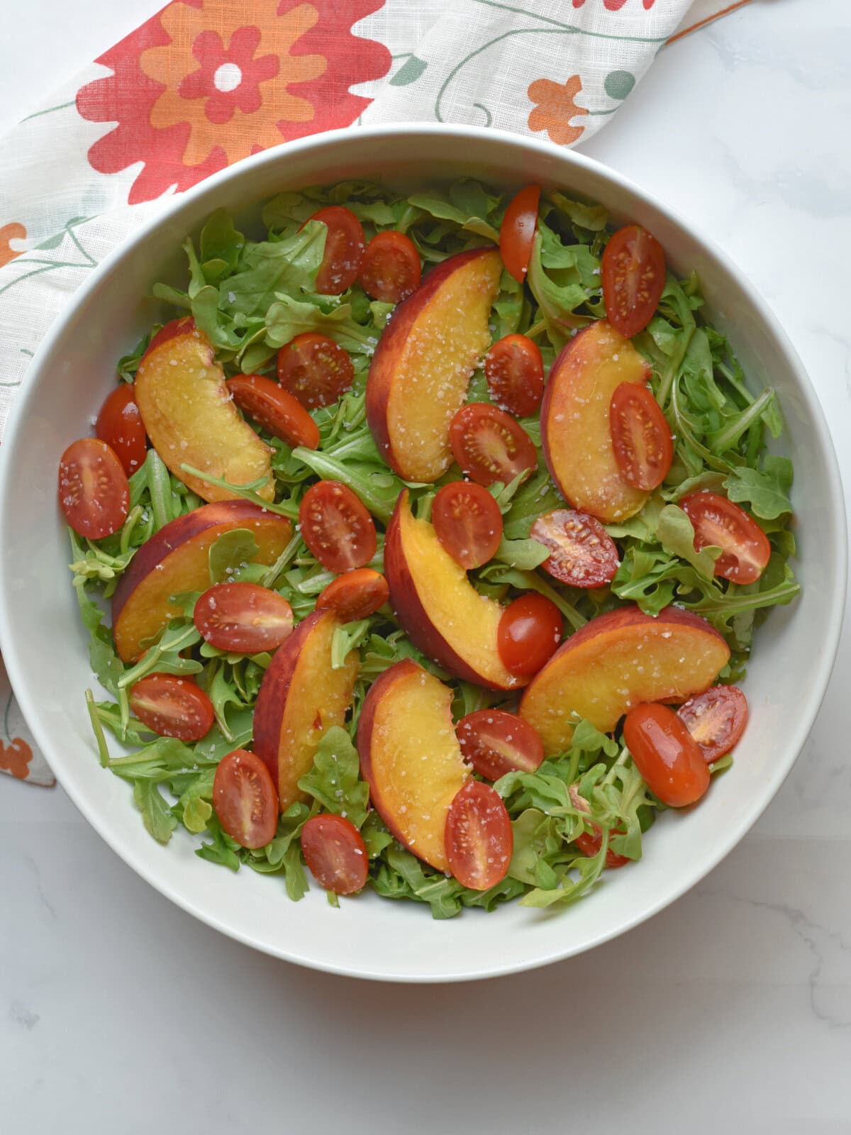 Sunshine-Cake-Ingredients-Bowl Peach Burrata Salad with salt and pepper.