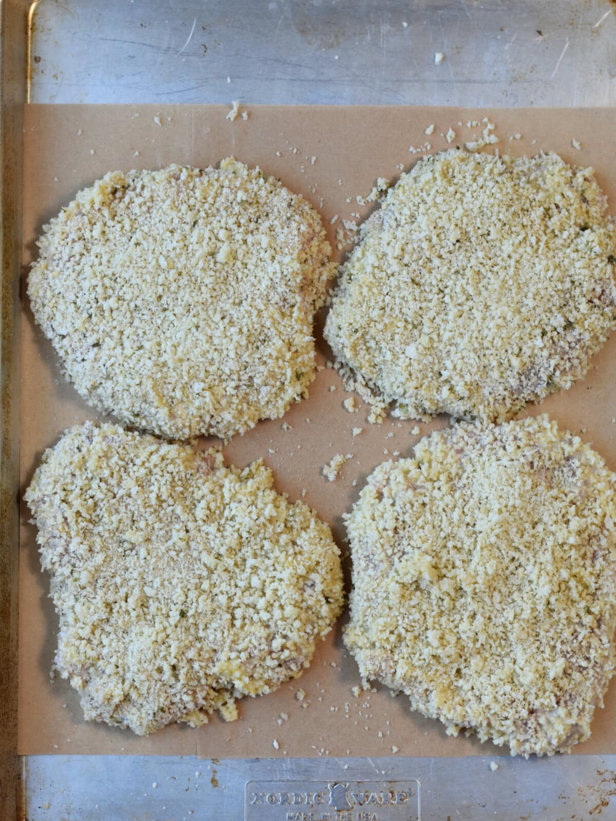 Breaded uncooked pork cubed steak. 