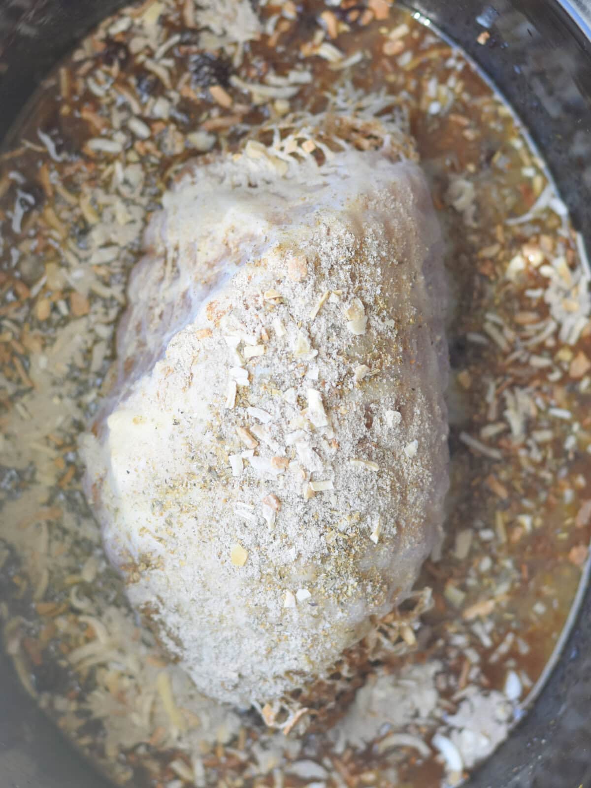 Dry onion soup mixture on the meat with gravy in a crock pot. 