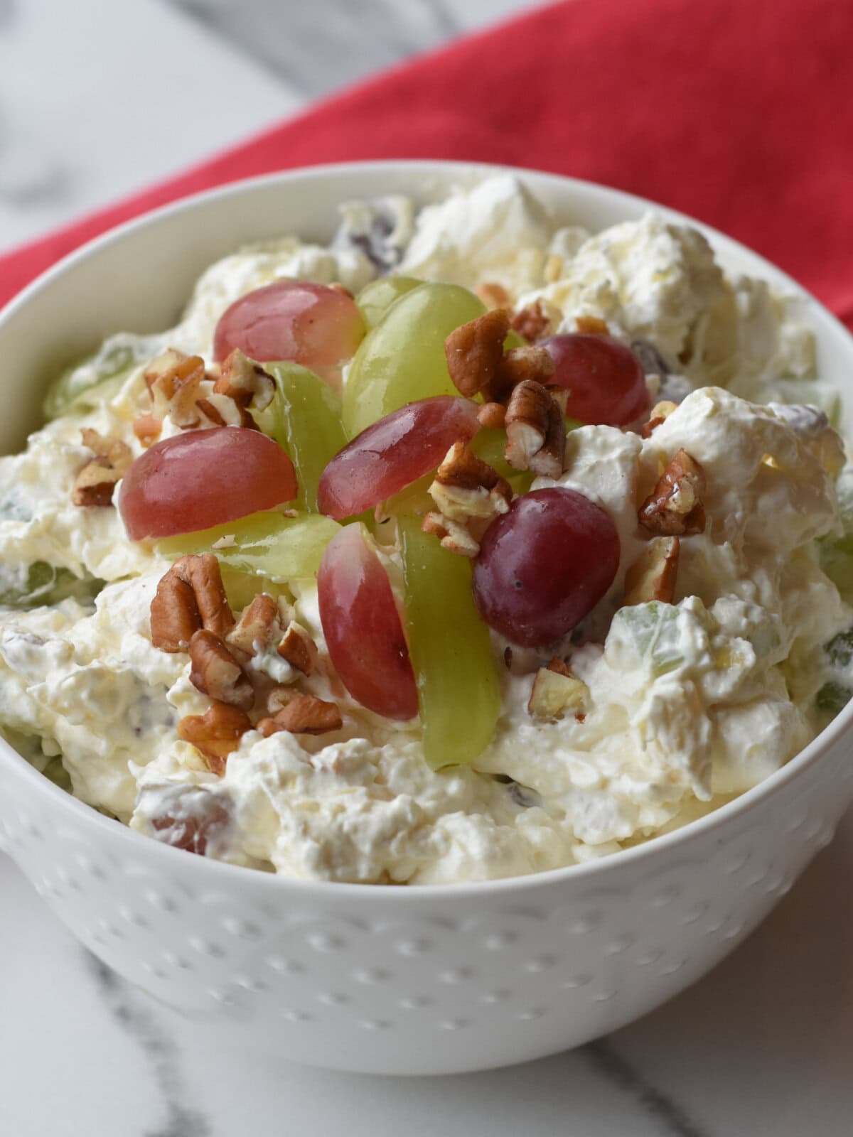 Christmas-Fruit-Salad-bowl Christmas Fruit Salad made with fluffy dressing, crushed pineapple, celery and pecans.