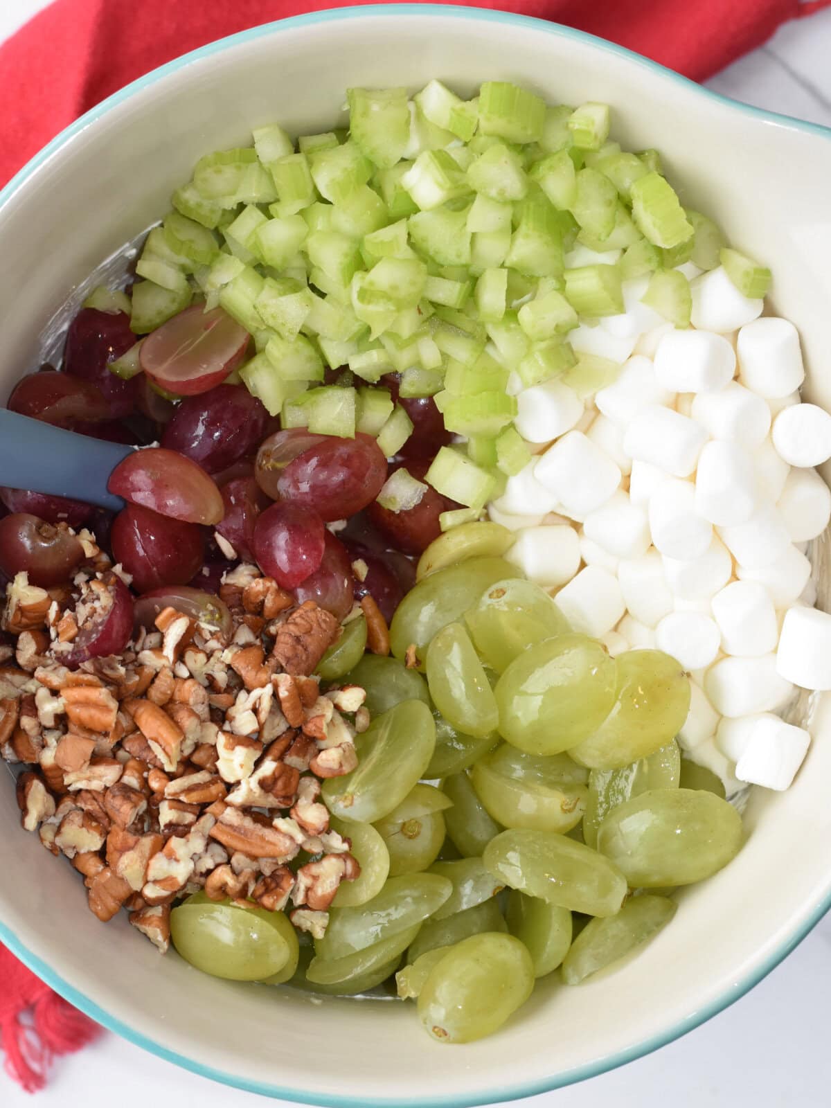 christmas-fruit-salad-unmixed Grapes, marshmallows, celery, pecans and mash mixed together.