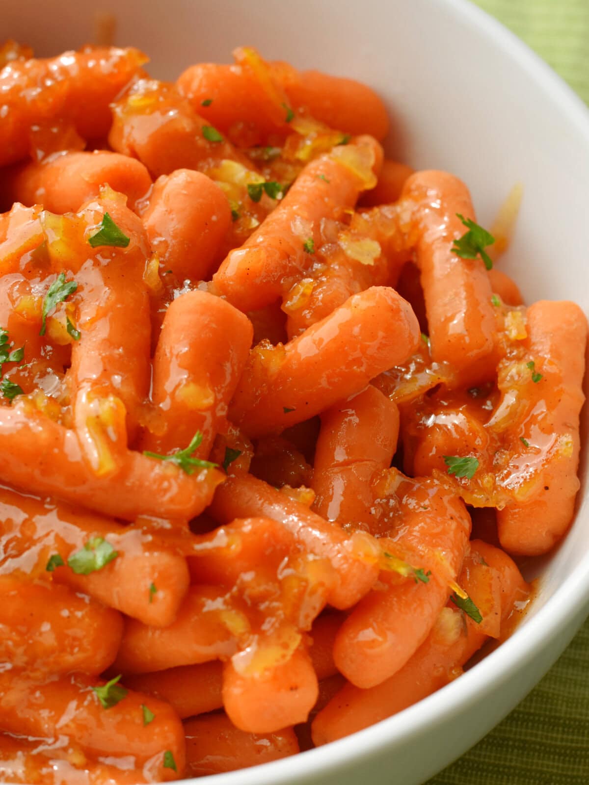carrots-orange-marmalade-served Bowl of glazed carrots with orange marmalade made with spicy brown mustard in a brown bowl.