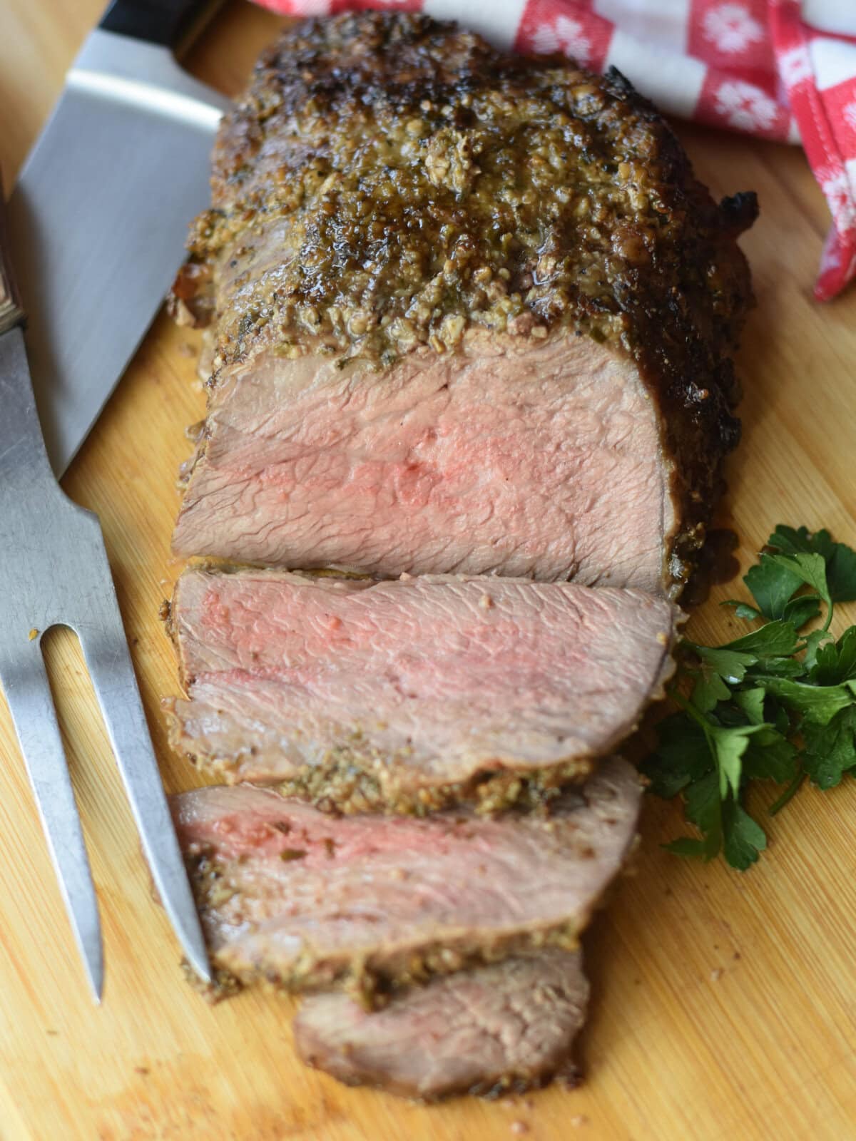 Perfectly cooked beef tri tip steak on a cutting board. 