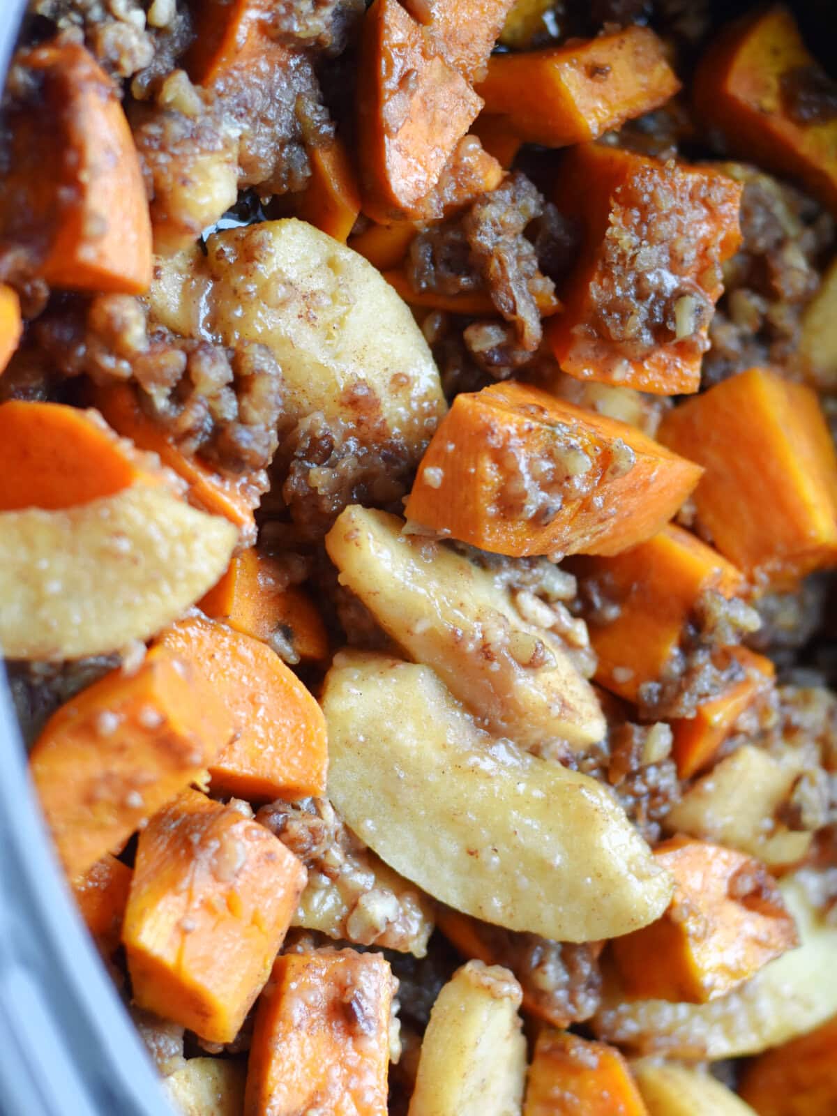 Cooked sweet potatoes and apples fully cooked in a slow cooker. 