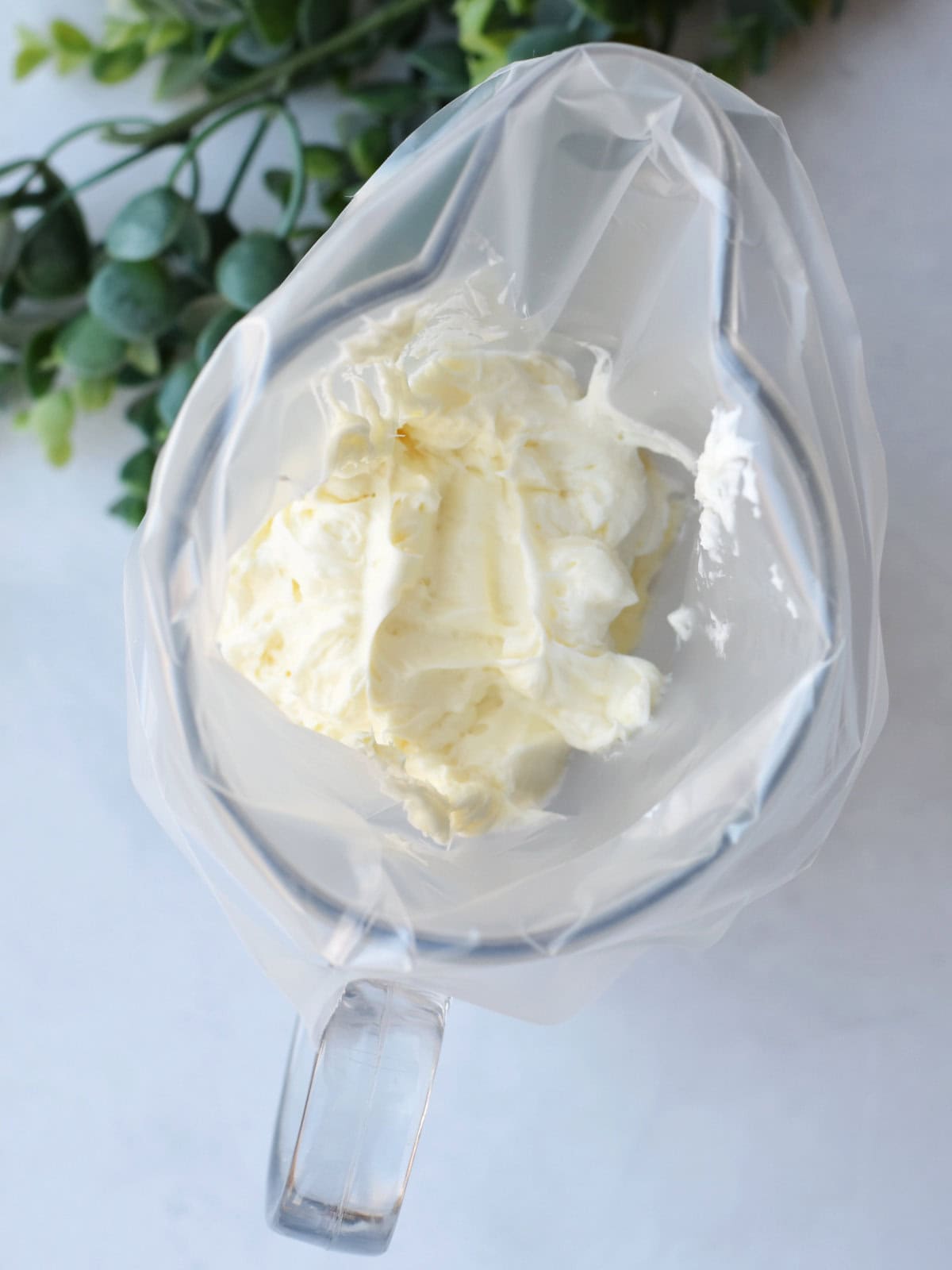 Filling in a bag inside a tall pitcher. 