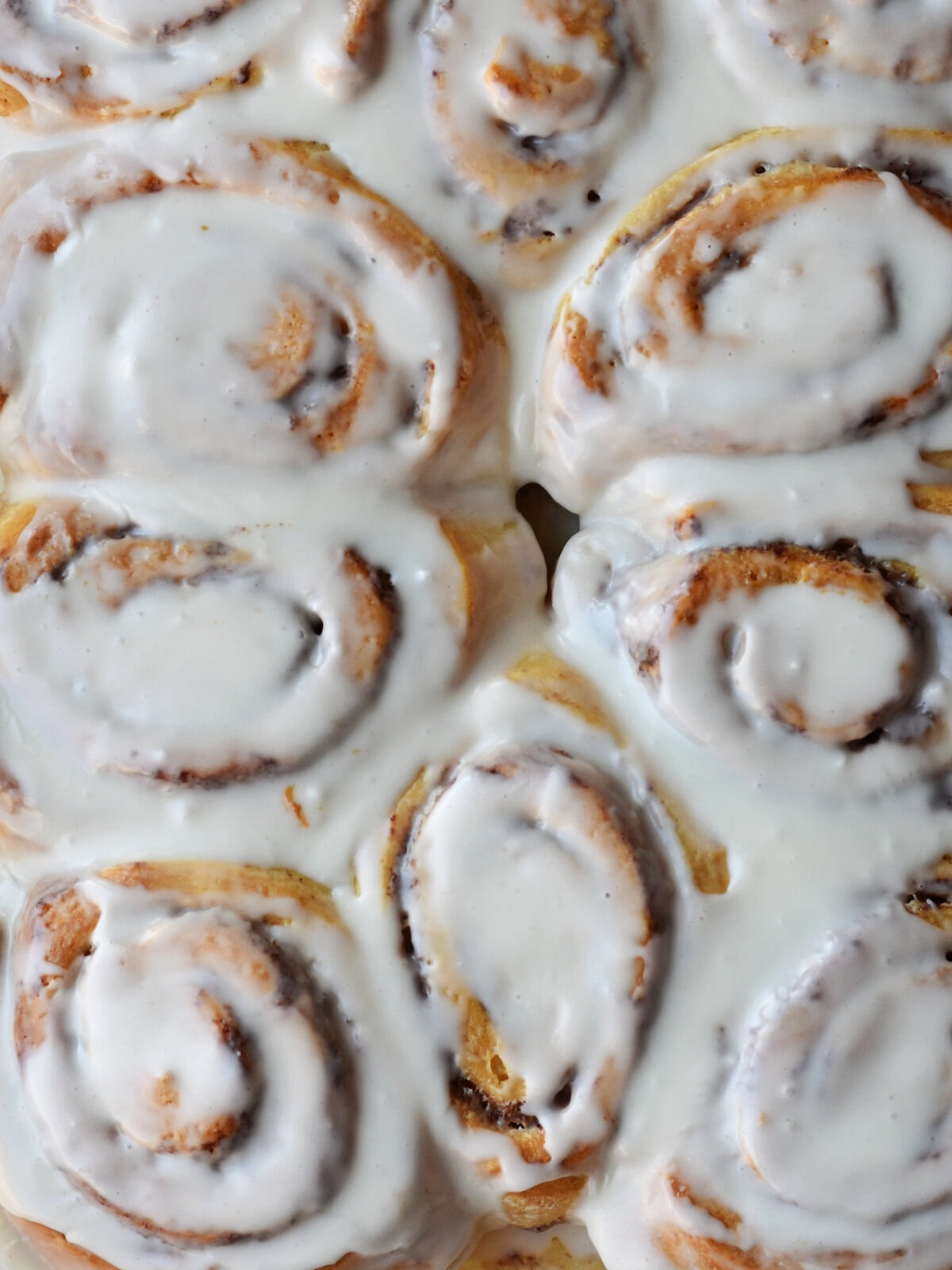 Frosted rolls in a baking dish. 