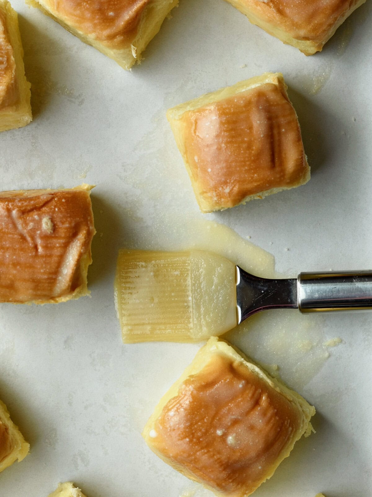 Buttered rolls on a cutting board. 