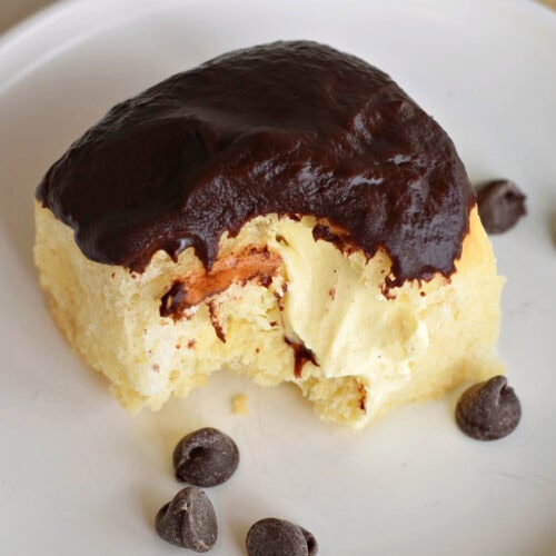 Boston Cream Pie Hawaiian Roll with chocolate chips on a white plate.