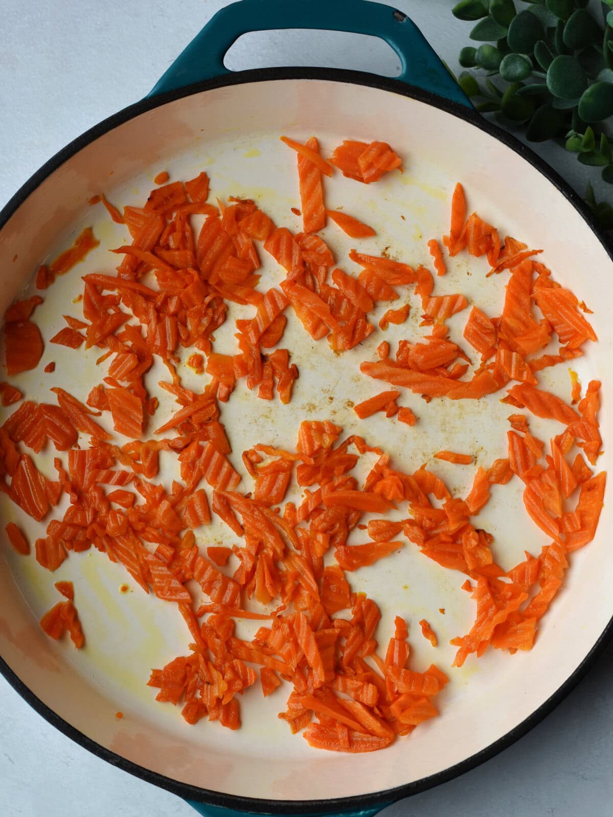Sautéing carrots in a skillet. 