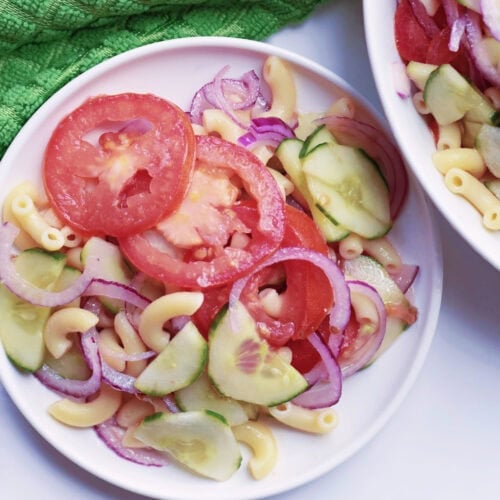 Easy summer cucumber pasta salad on a white plate.