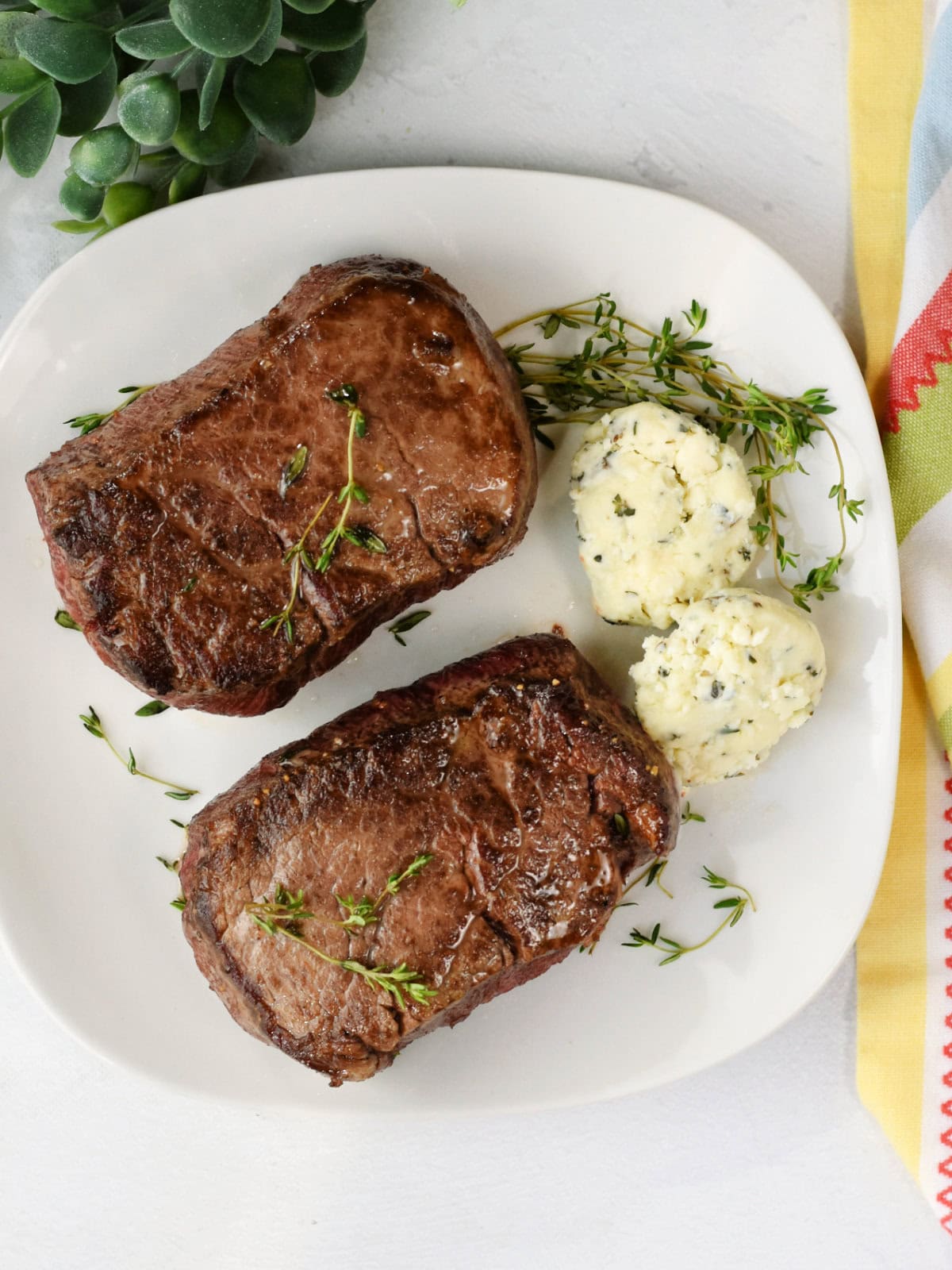 filet-mignon-oven-cooked Filet mignon made in the oven with homemade bleu cheese butter on a plate.