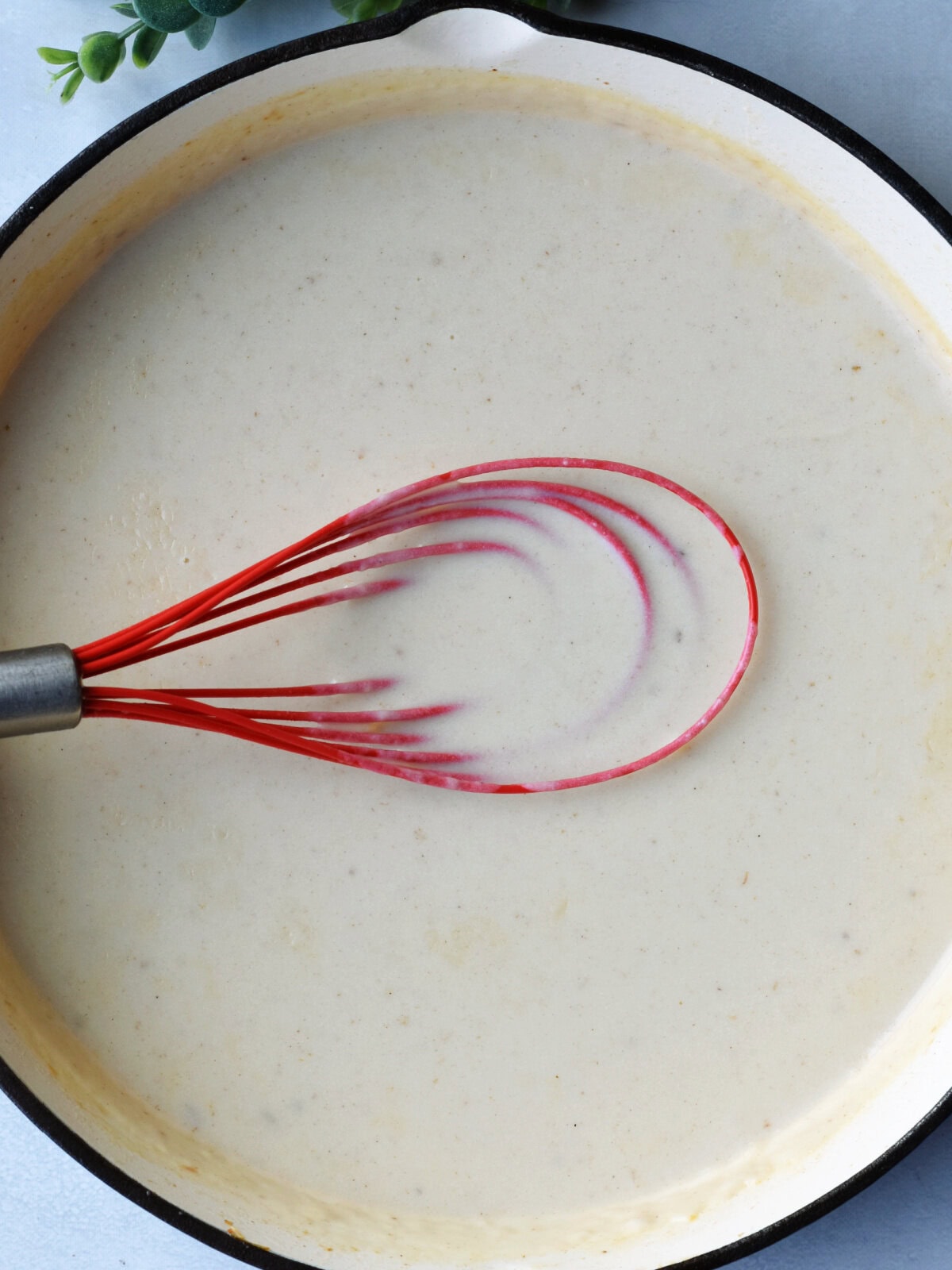ham-steak-potatoes-sauce A cooking skillet on top of the oven with sauce made from butter and flour.