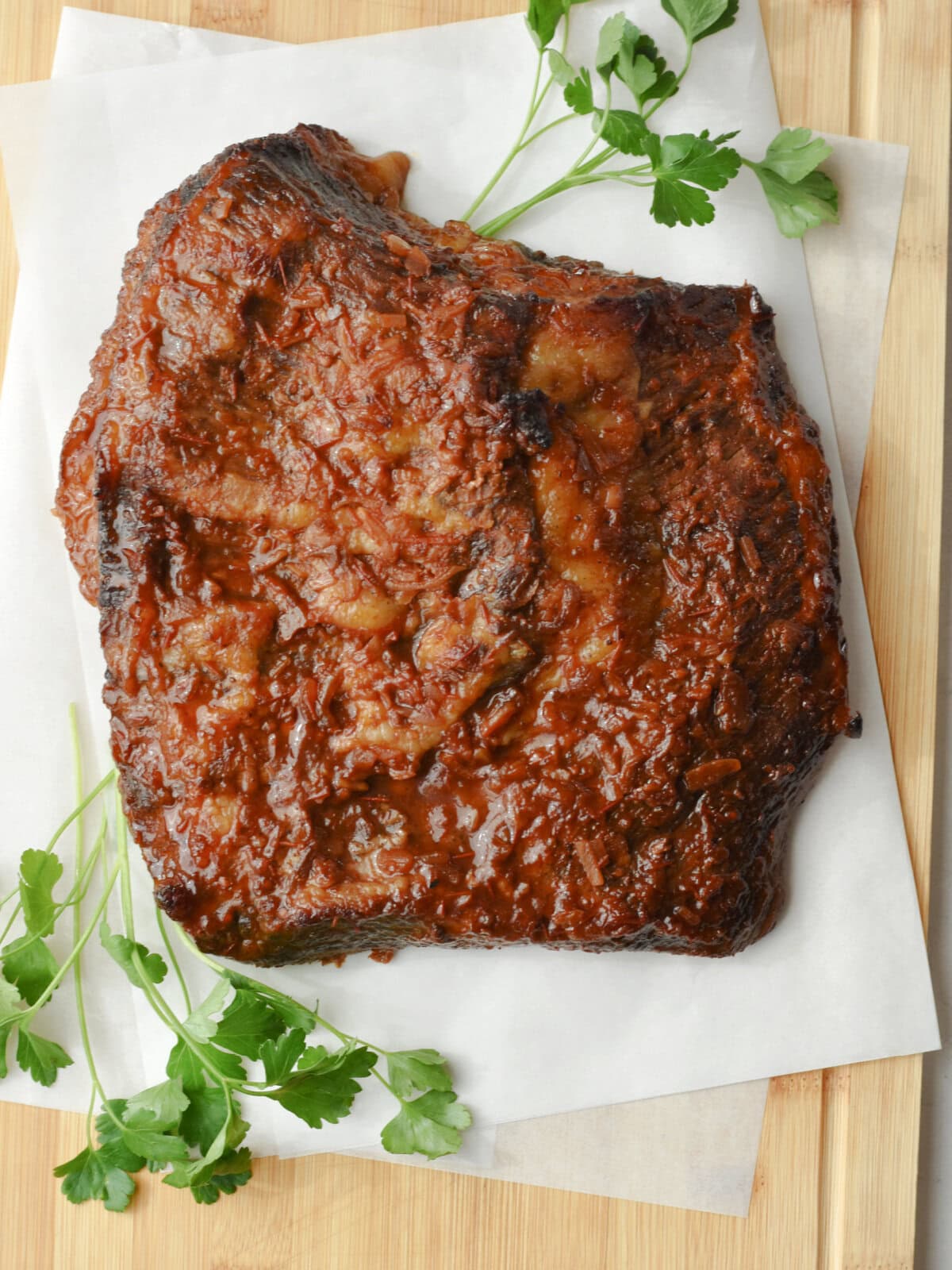 Beef brisket that is resting on a cutting board. 