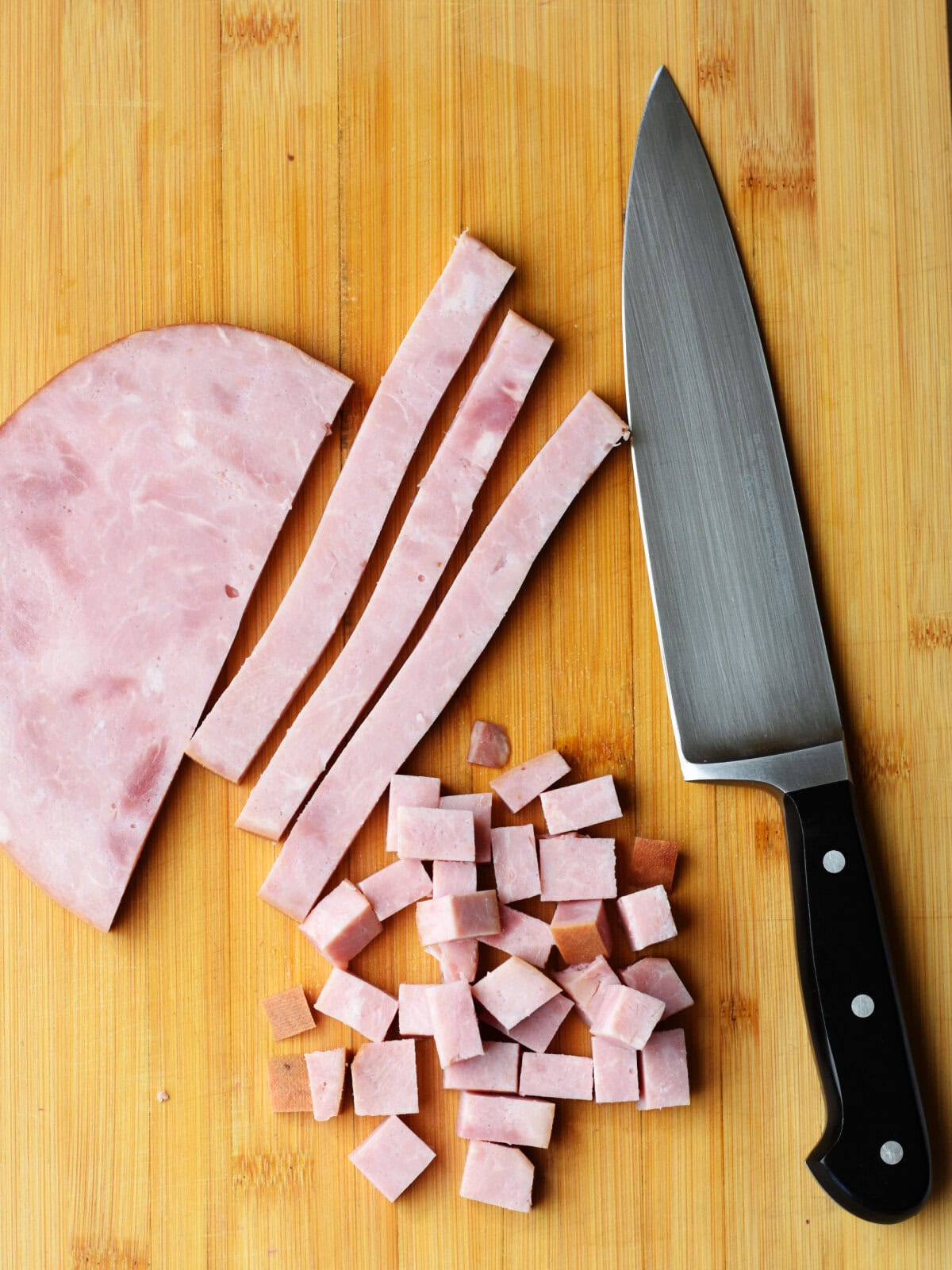 Diced Ham steak on a cutting board.