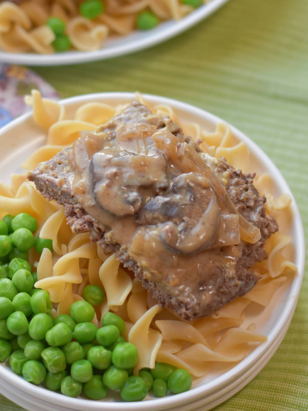 crockpot-round-steak-gravy Crockpot Round Steak made with cream of mushroom soup, sliced mushrooms and served over a bed of egg noodles.