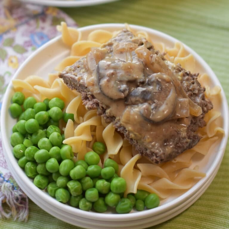 Crockpot round steak with peas and noodles.