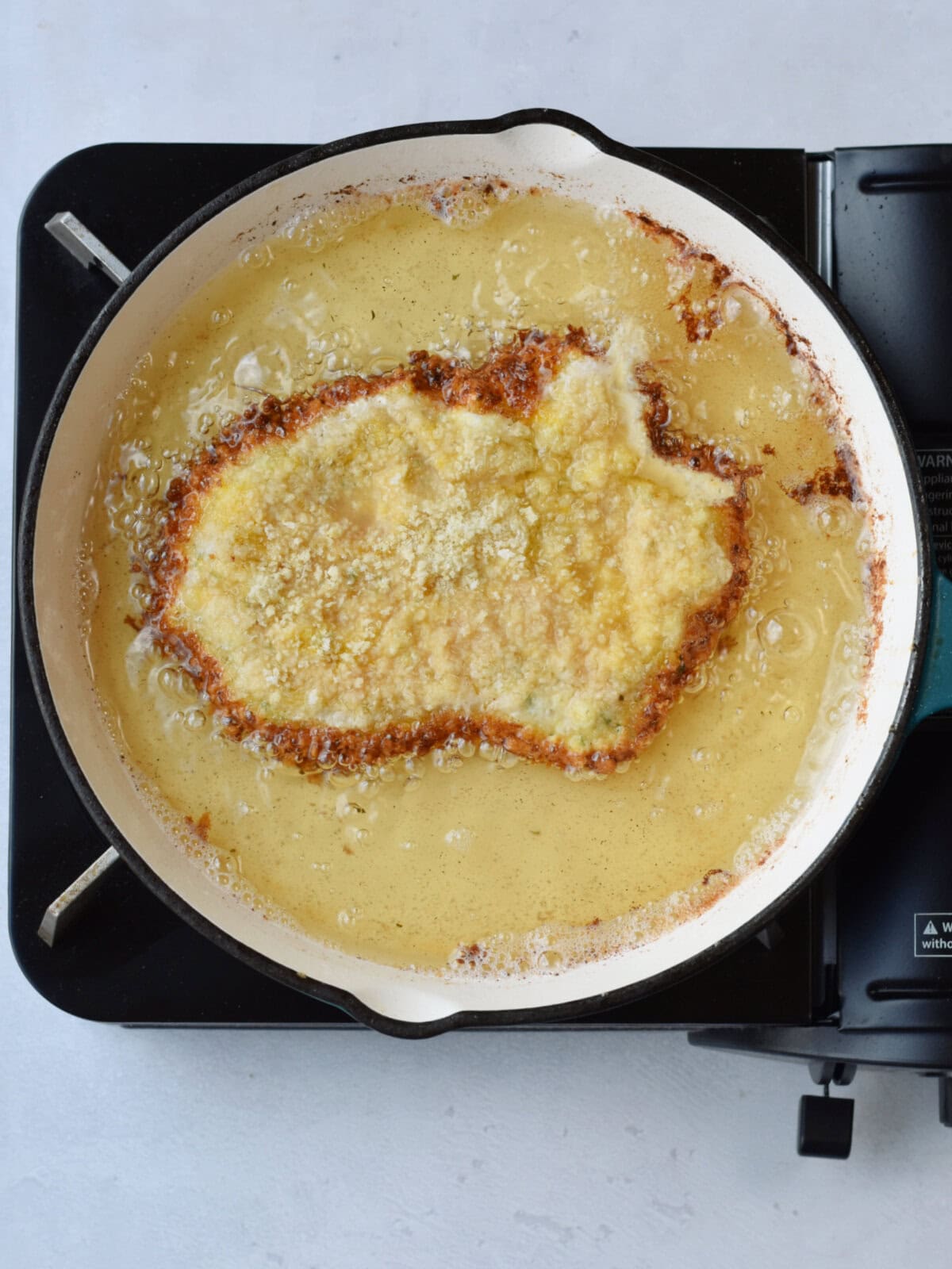 Frying meat in a frying pan. 