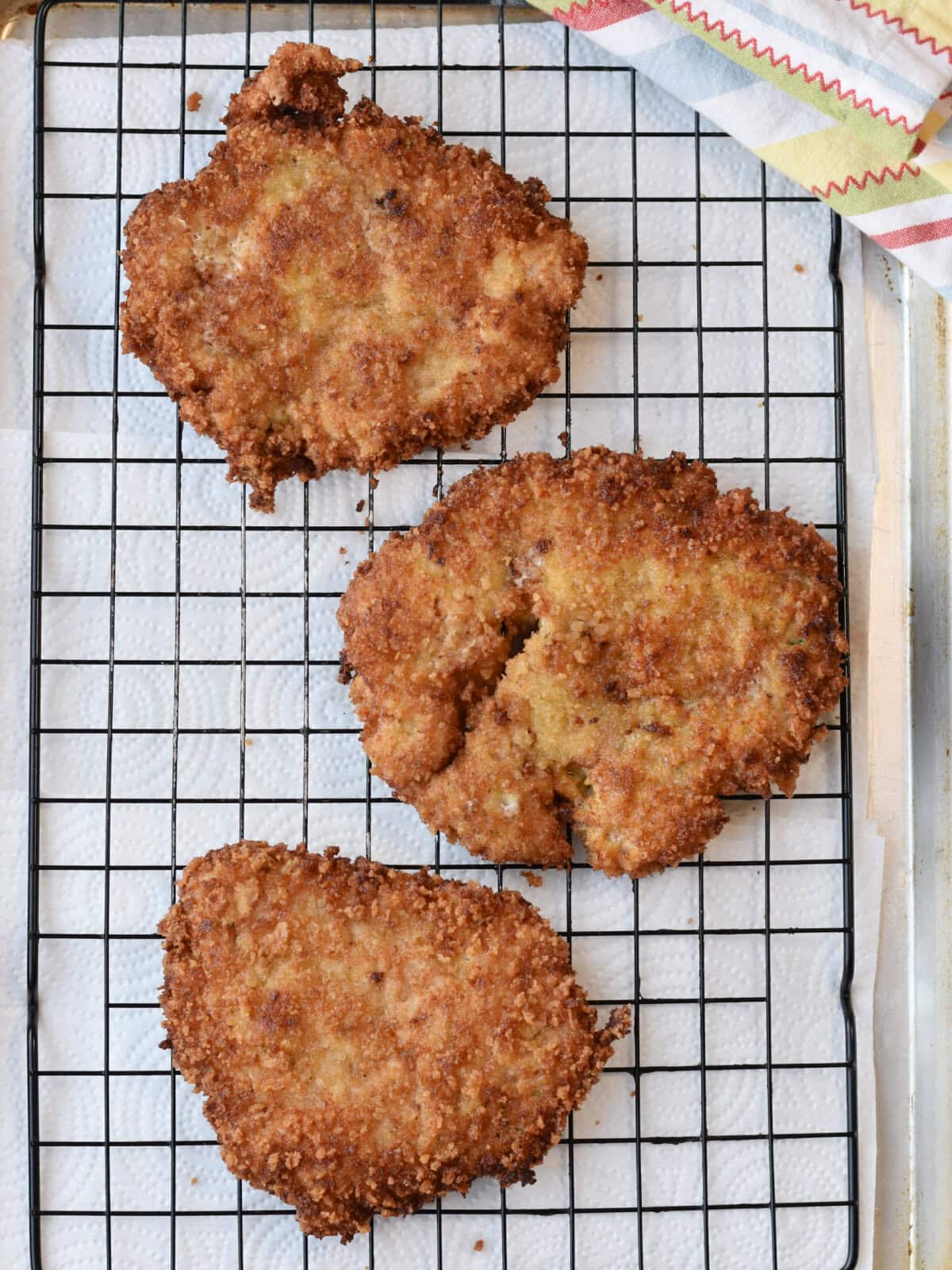 Fried pork cutlets on a wire rack. 