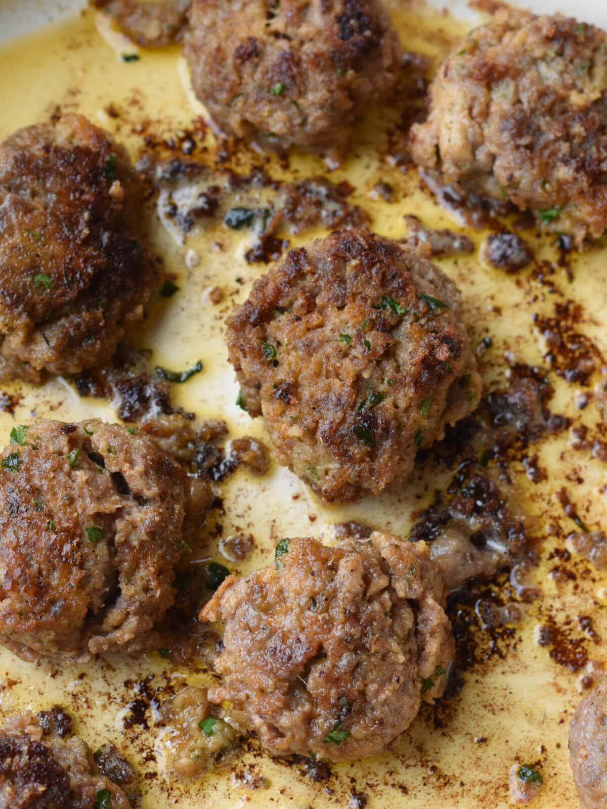 Browned meat in skillet. 