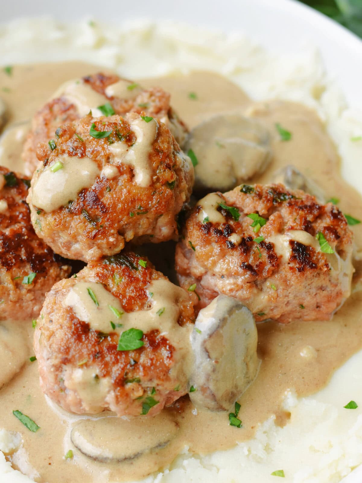 Pork meatball stroganoff on a bed of mashed potatoes. 