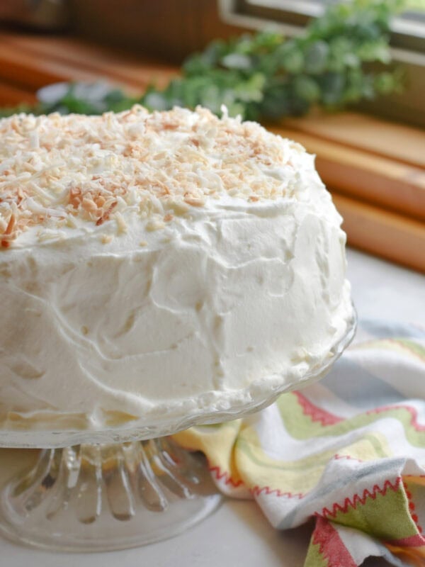 Chilled Coconut Cake made with Cake mix fully frosted. 