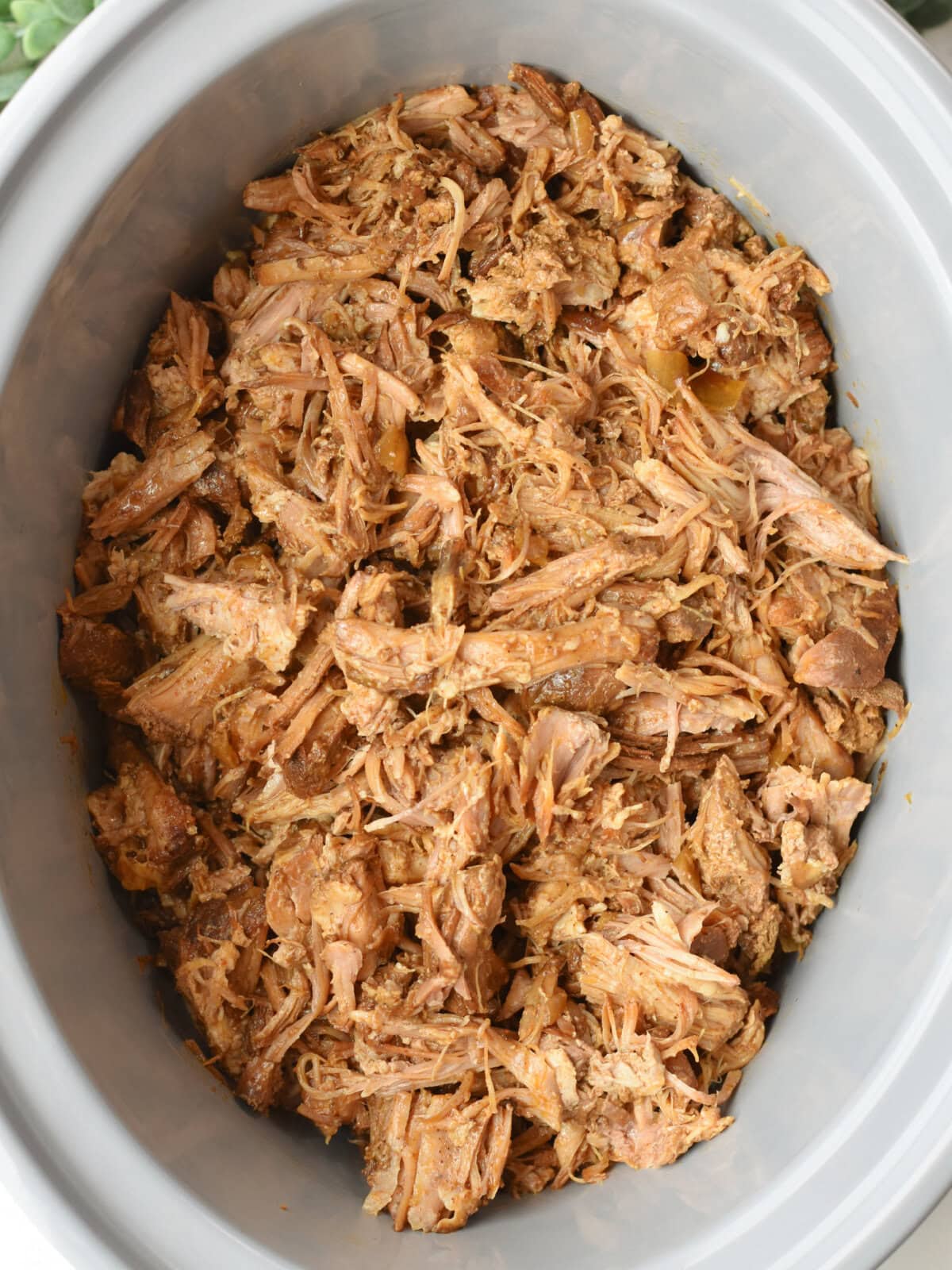 Shredded pulled pork in a slow cooker