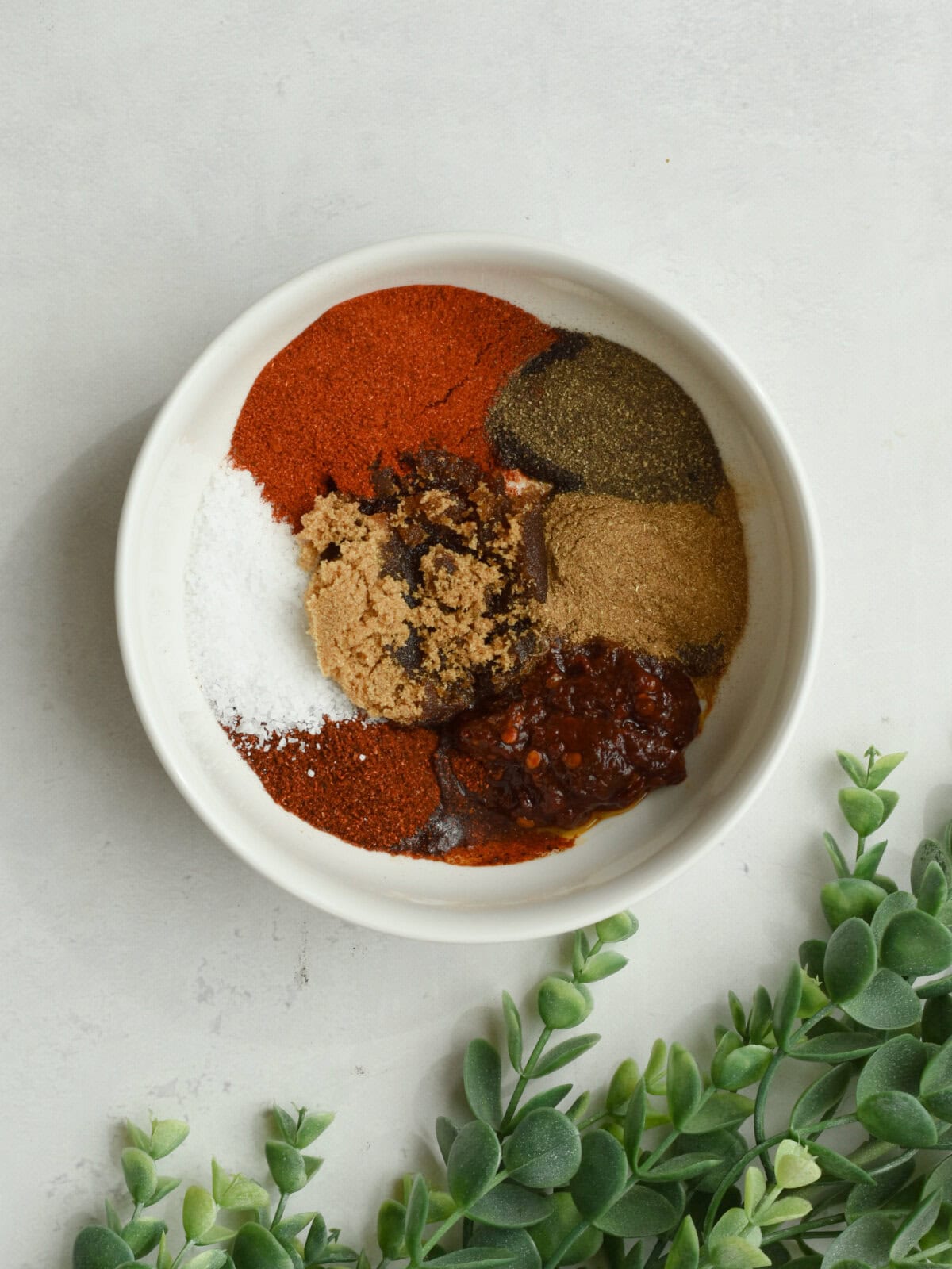 Seasonings with chipoles in adobo sauce in a small bowl. 