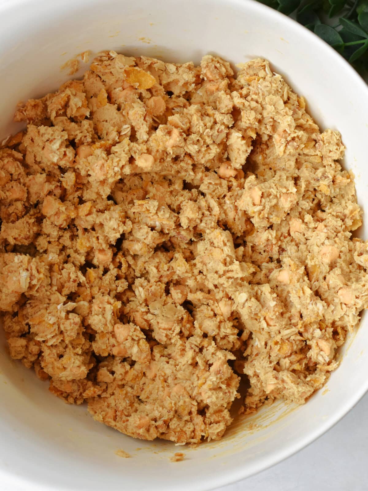 Hand mixed combined batter in a white mixing bowl. 