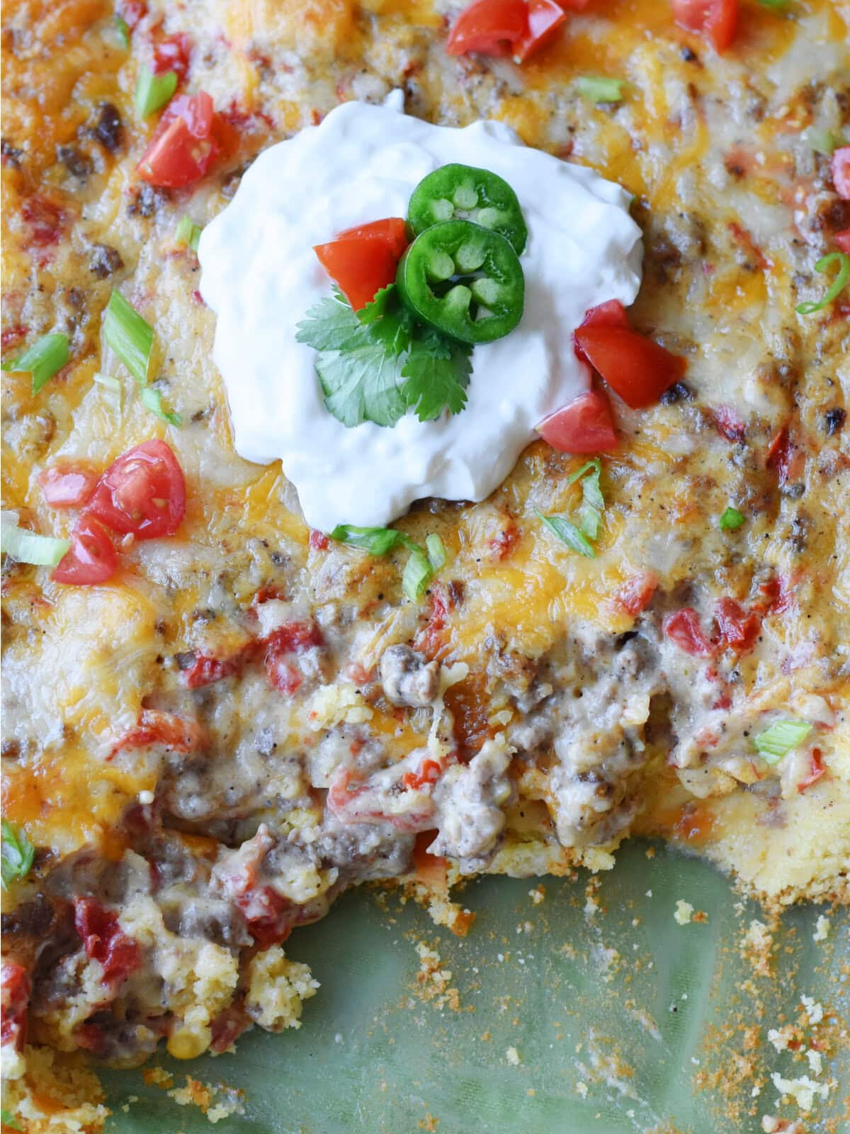 Cowboy cornbread casserole with sour cream and tomatoes. 