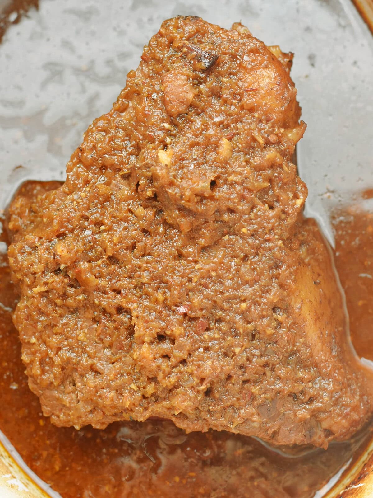 Fully cooked beef in a slow cooker with it's juice.
