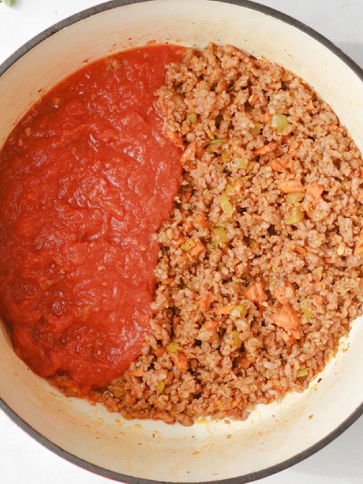 Crushed tomatoes in meat in a pan. 