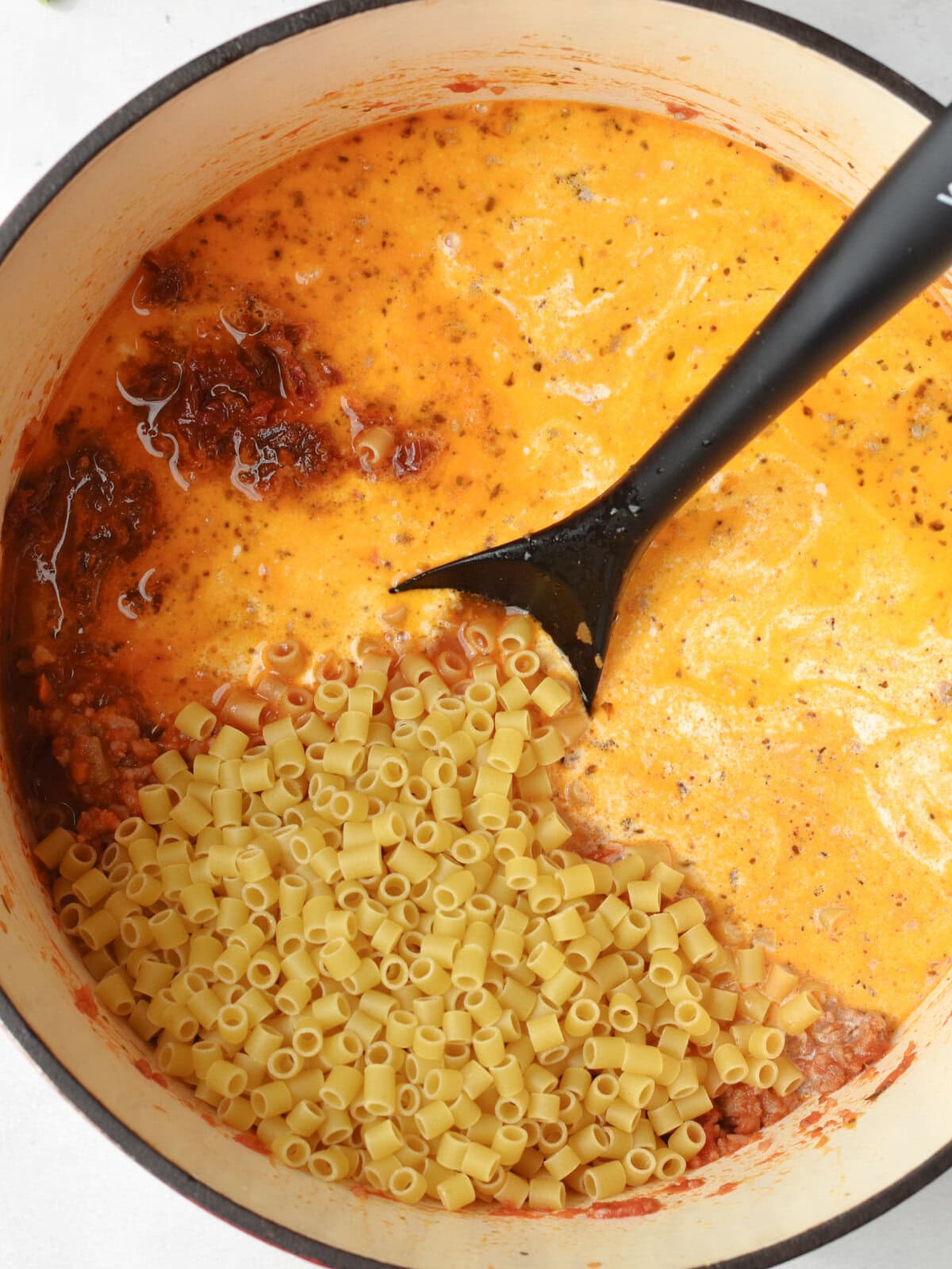 Uncooked pasta in a creamy soup. 