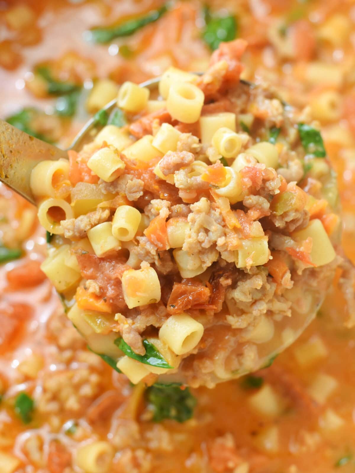 A spoon full of Creamy Italian Sausage Soup. 