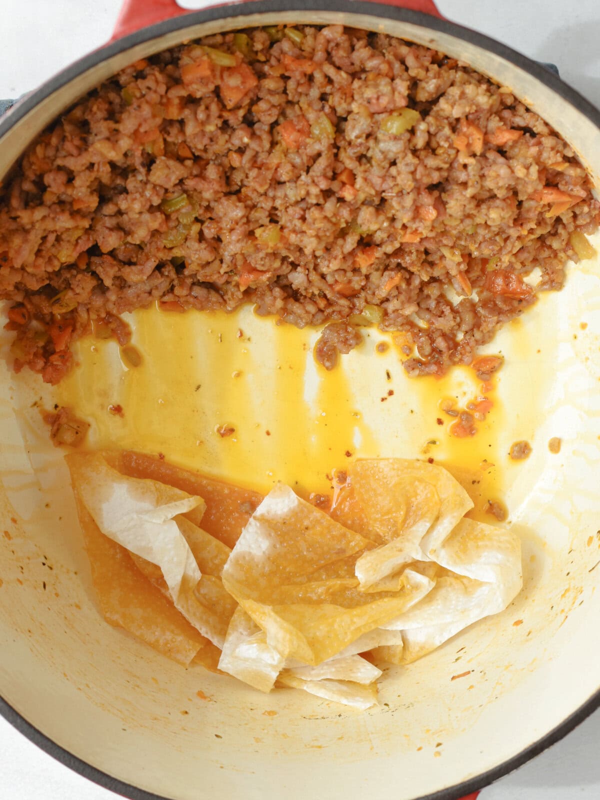 Draining fats from meat in a pan. 