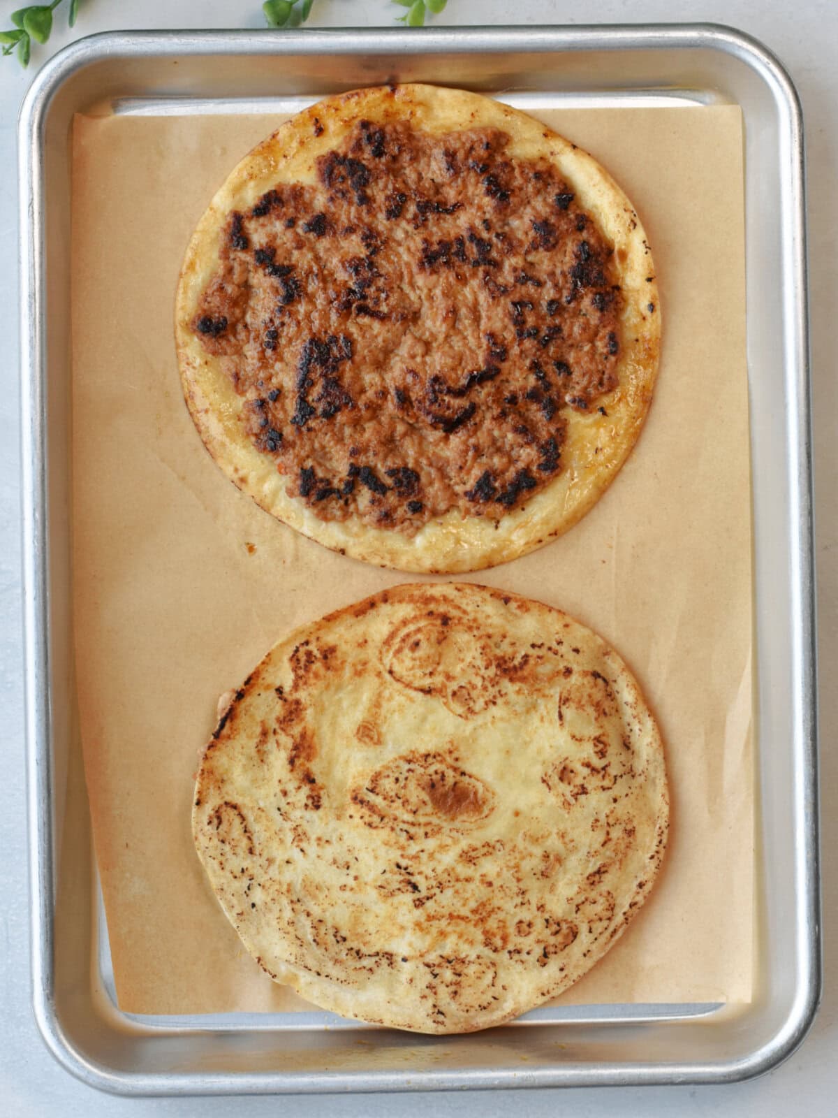 Tortillas with browned meat partially cooked. 